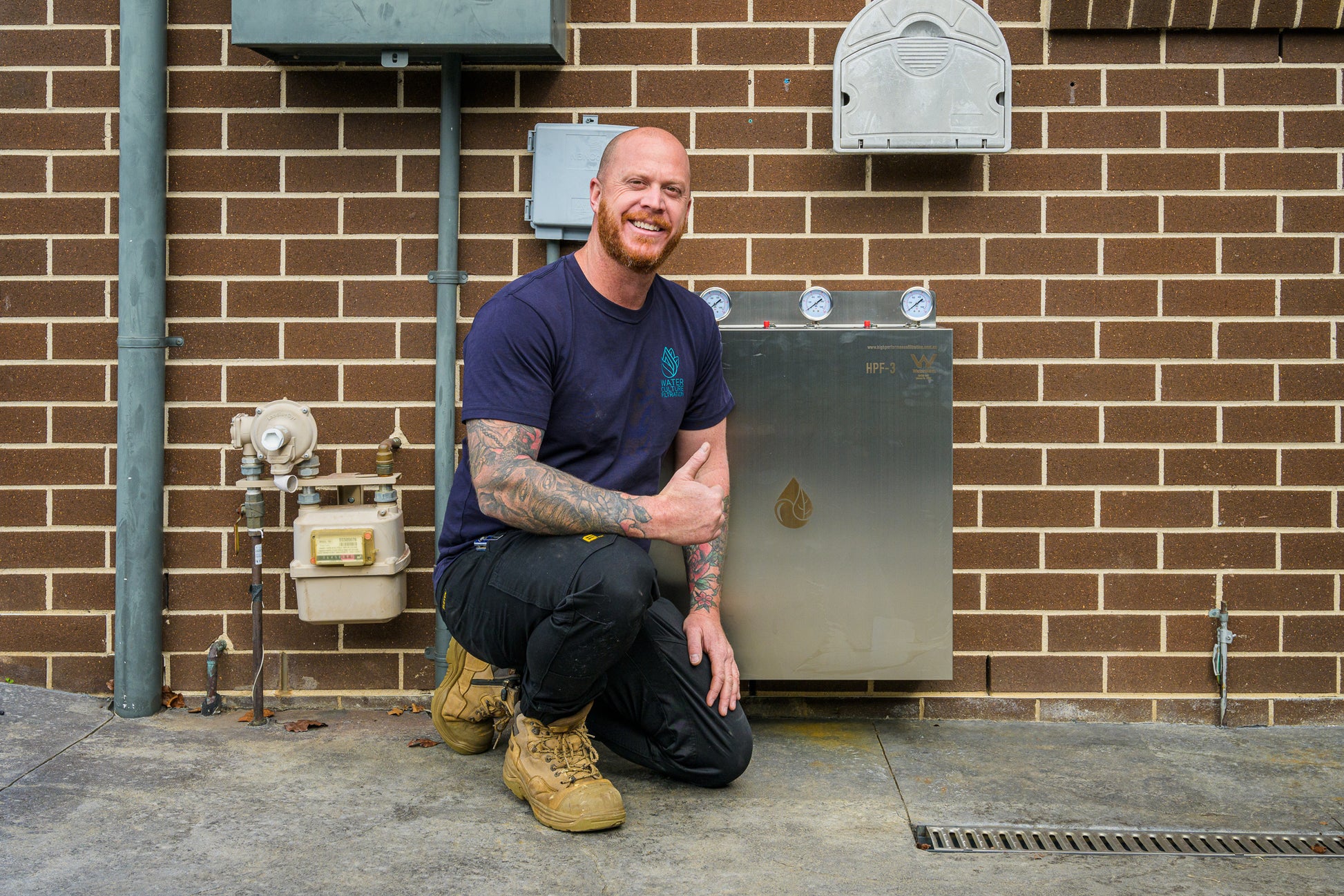 Mark from Water Culture Filtration posing with a newly installed full-house water filtration system.